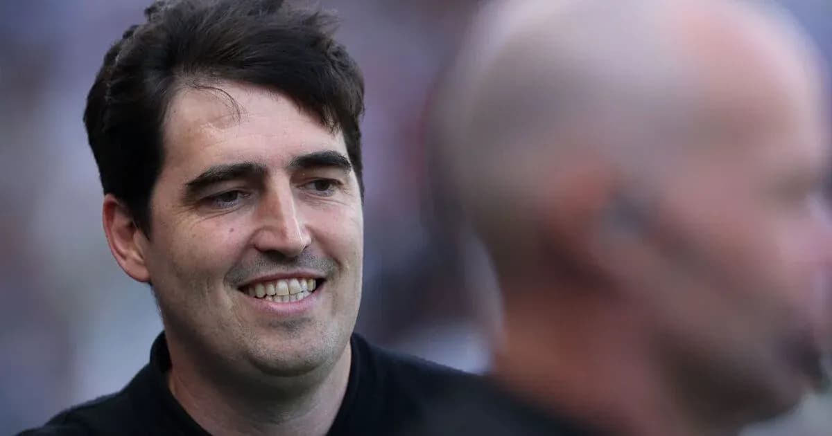 Man smiling during an event with another person Man smiling during an event with another person