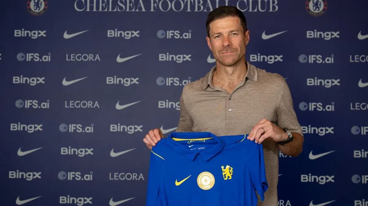 New manager holding Chelsea jersey at press event New manager holding Chelsea jersey at press event