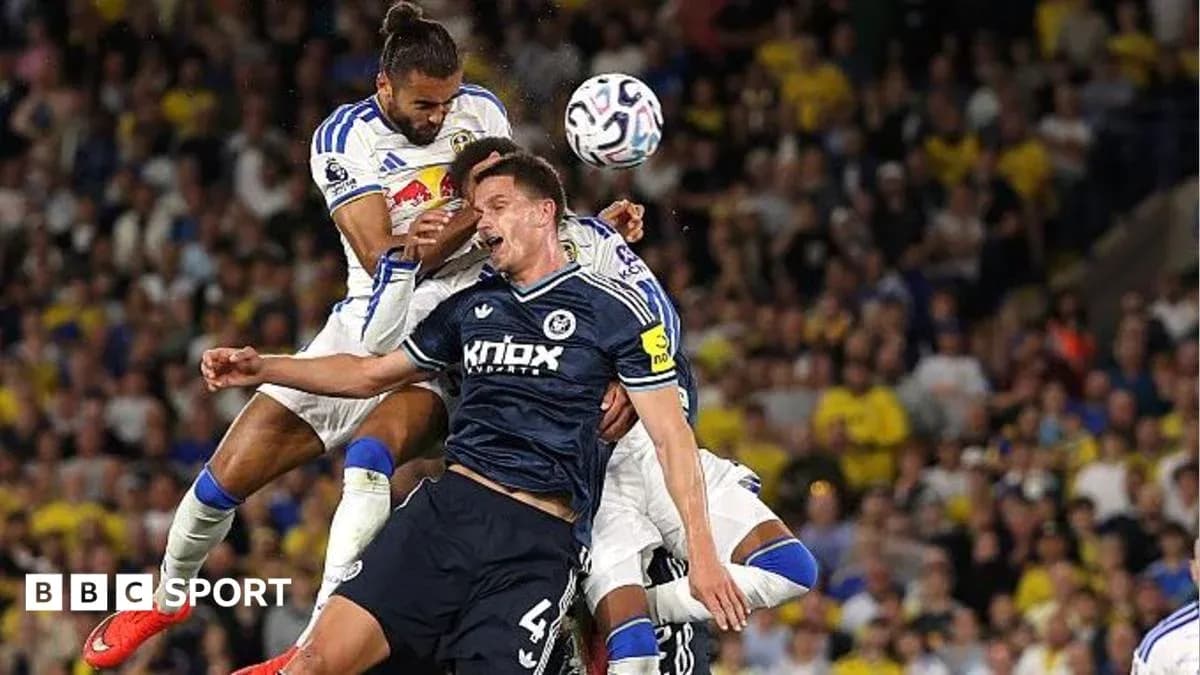 Players contesting a high ball during match action Players contesting a high ball during match action