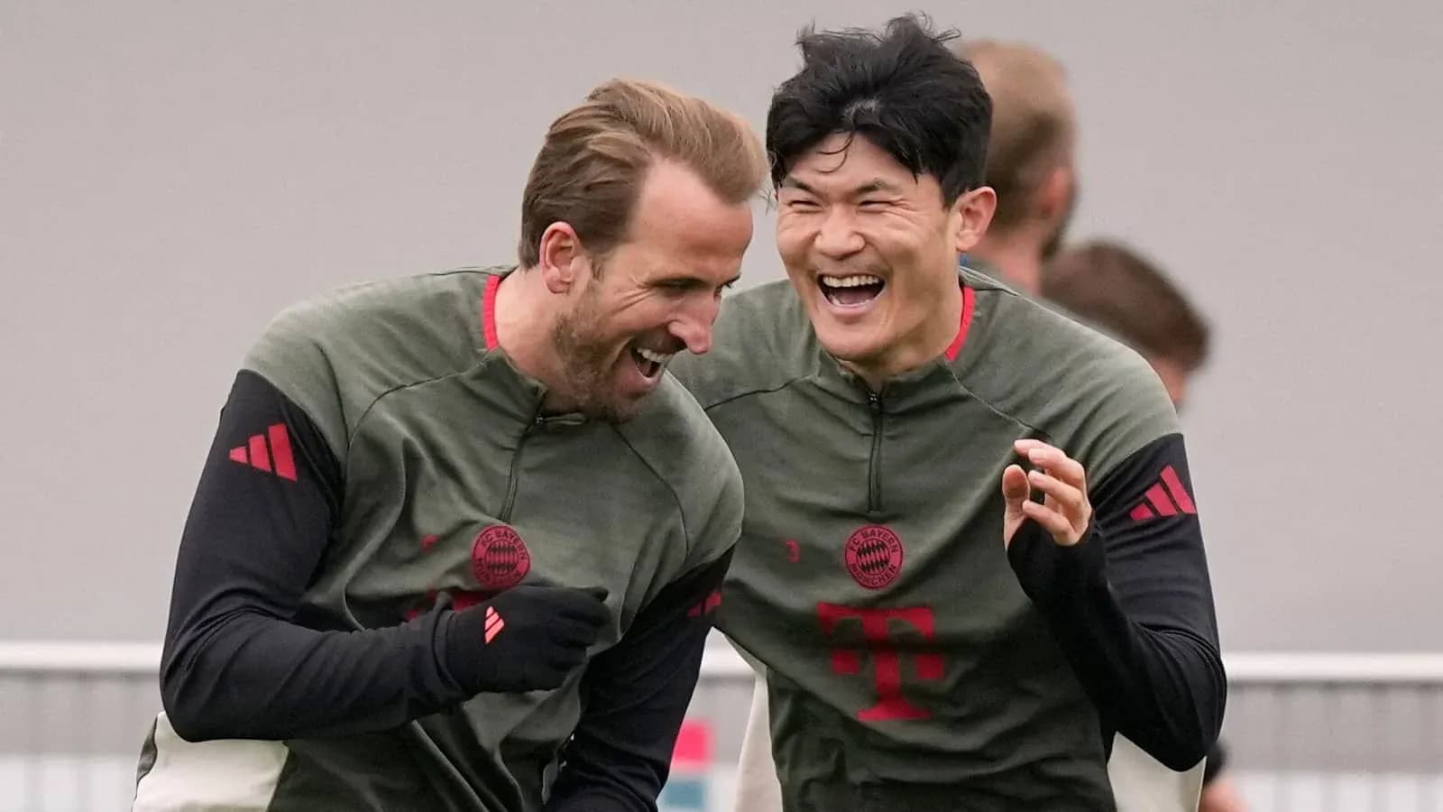 Two Bayern Munich players laughing during training session Two Bayern Munich players laughing during training session