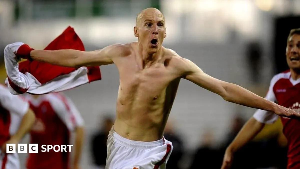 Player celebrating with shirt raised after scoring goal Player celebrating with shirt raised after scoring goal