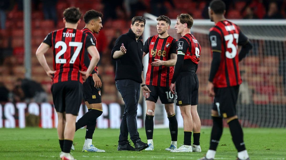 Coach discussing strategy with Bournemouth players during match Coach discussing strategy with Bournemouth players during match