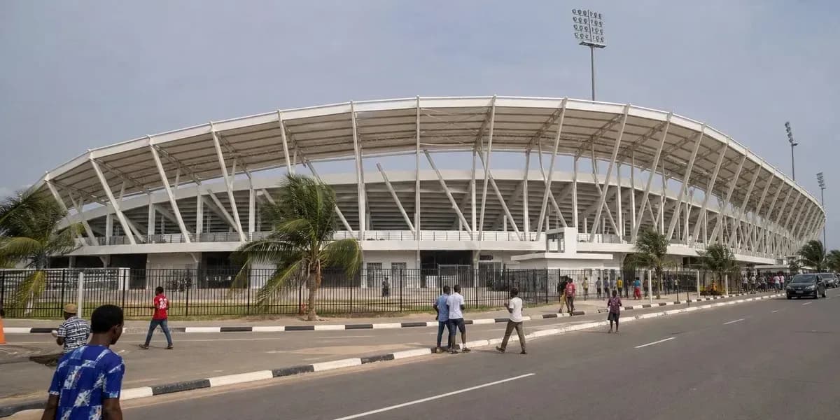 Exterior view of stadium with pedestrians nearby Exterior view of stadium with pedestrians nearby