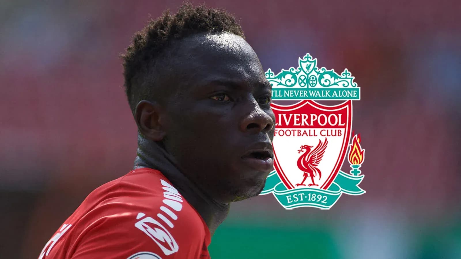 Player in Liverpool jersey with club logo background Player in Liverpool jersey with club logo background