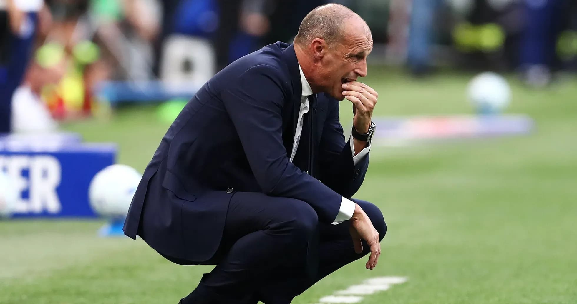 Coach crouching on sideline during match Coach crouching on sideline during match