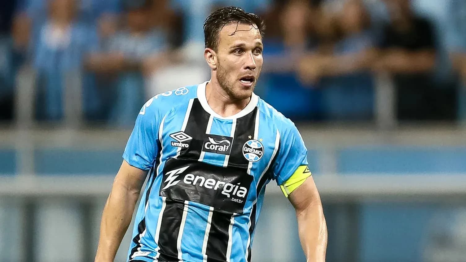 Player in blue and black jersey on the field Player in blue and black jersey on the field