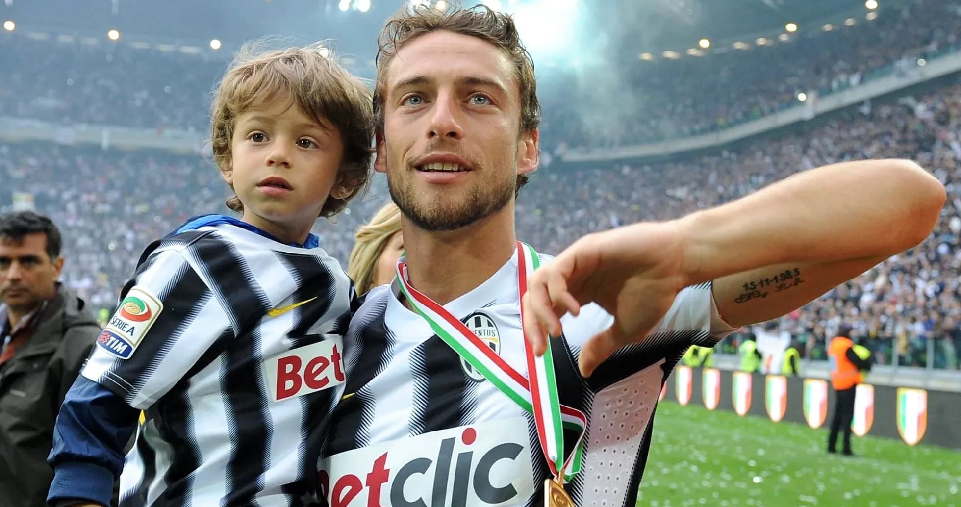 Player celebrating with child after match Player celebrating with child after match