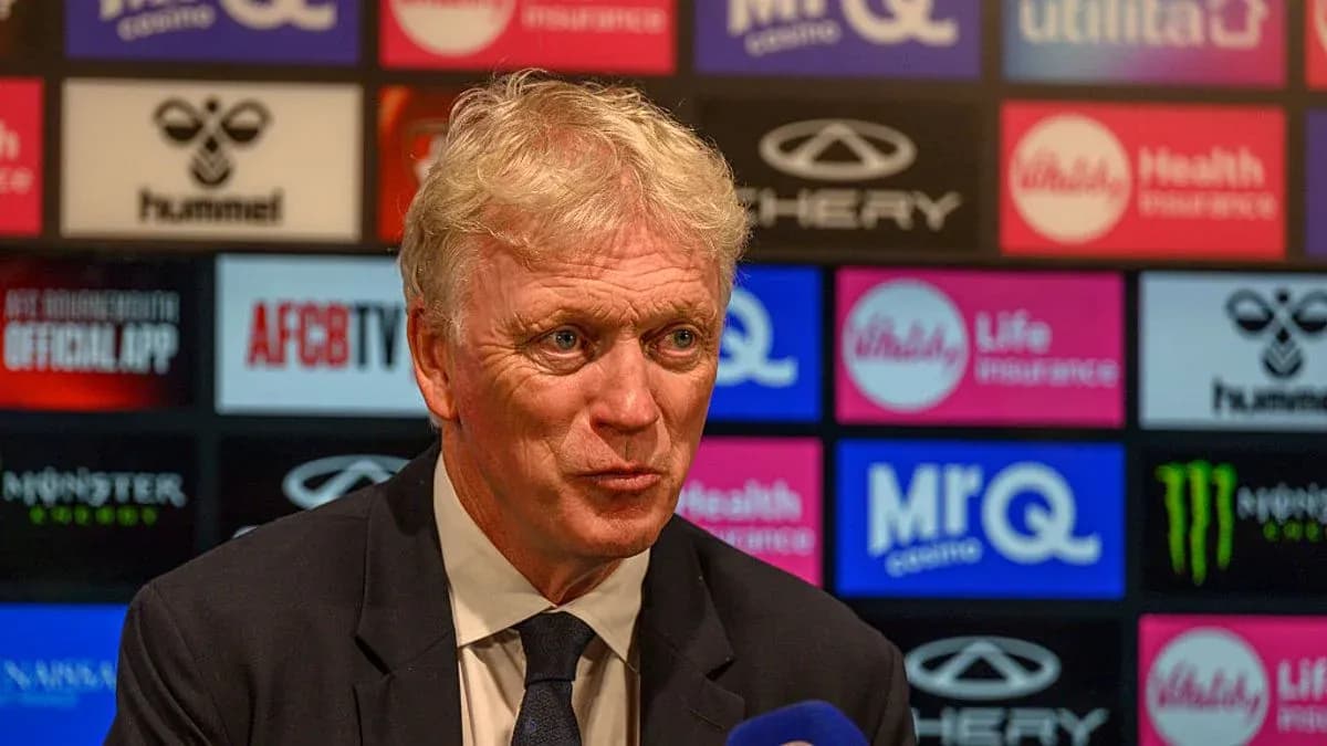 Manager speaking at press conference with logos behind Manager speaking at press conference with logos behind