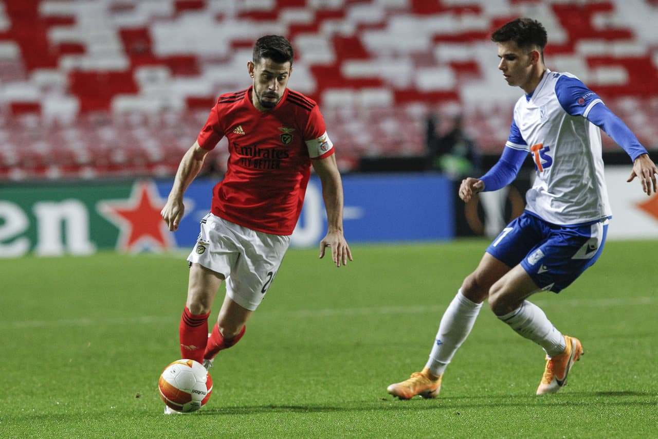 Benfica player dribbling against Lech Poznan opponent Benfica player dribbling against Lech Poznan opponent