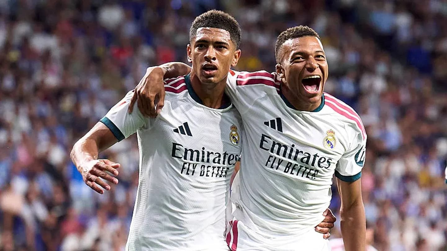 Two Real Madrid players celebrating a goal together Two Real Madrid players celebrating a goal together
