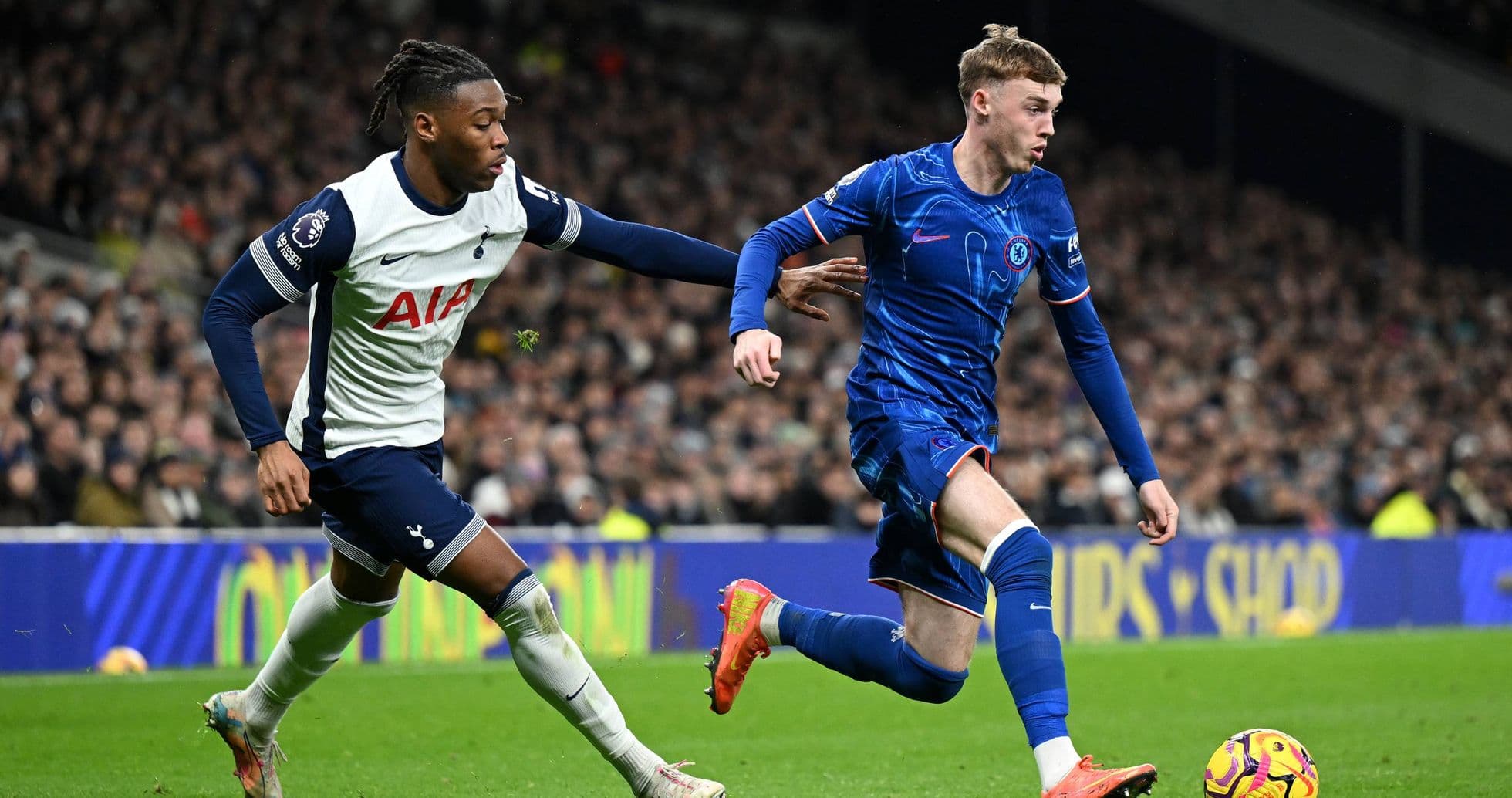 Chelsea player evading Tottenham defender during match Chelsea player evading Tottenham defender during match