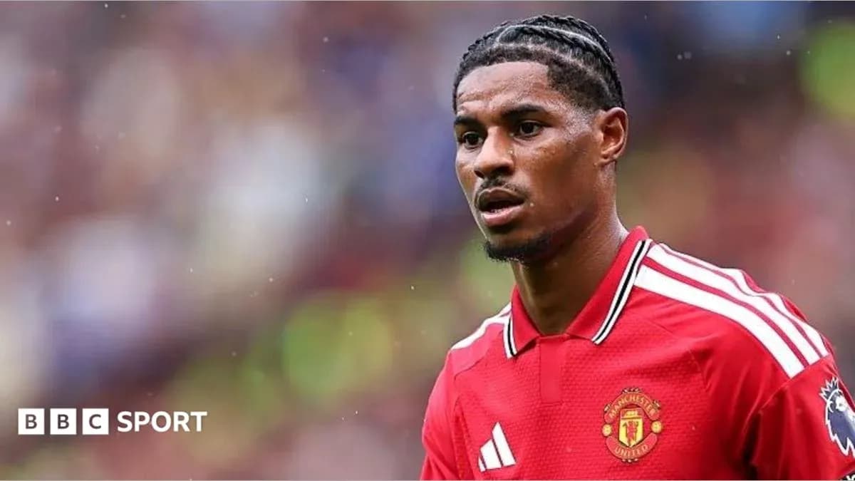 Player in red Manchester United jersey on field Player in red Manchester United jersey on field