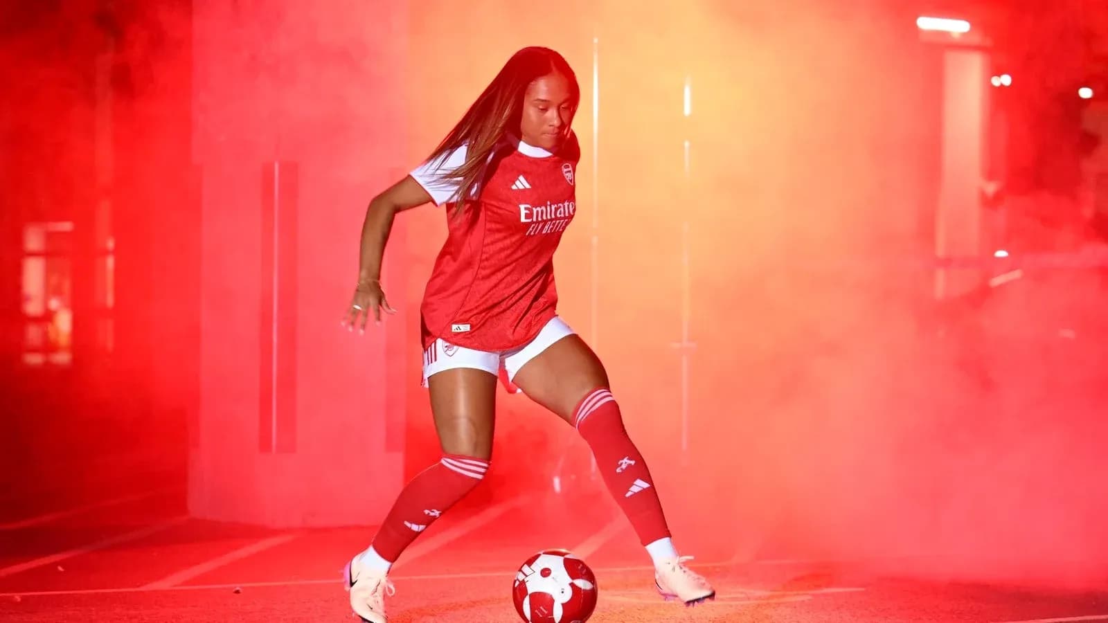 Player in Arsenal kit posing with soccer ball Player in Arsenal kit posing with soccer ball