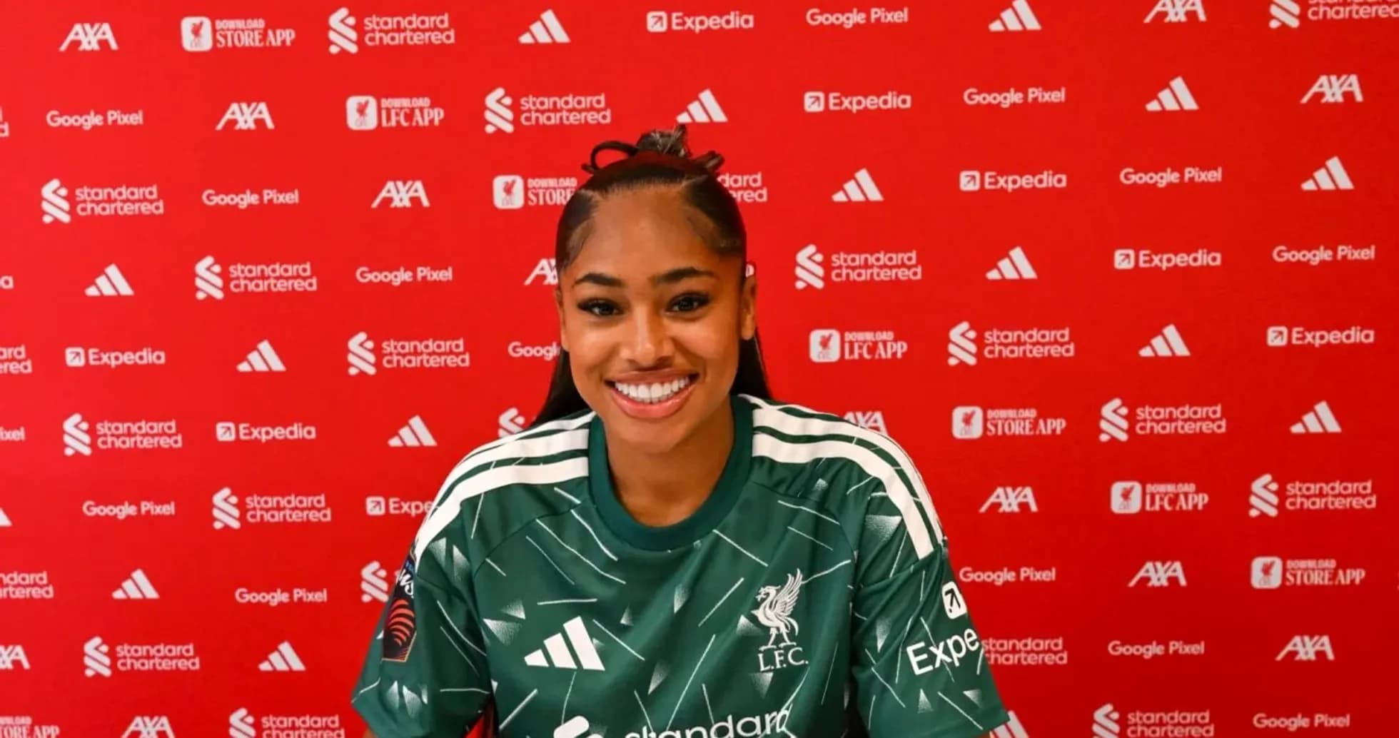 Player smiling at press conference with sponsor backdrop Player smiling at press conference with sponsor backdrop