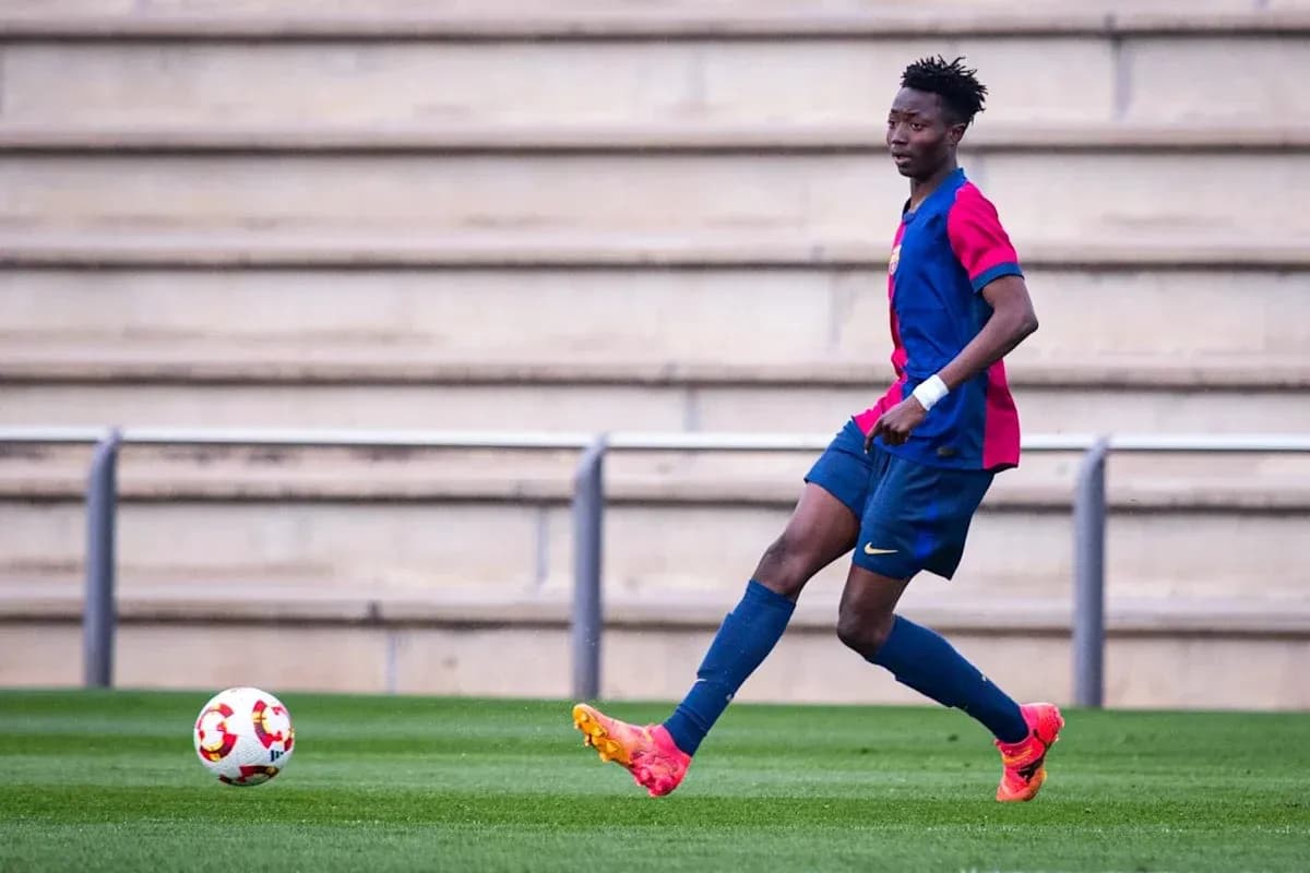 Player in Barcelona kit passing the ball on field Player in Barcelona kit passing the ball on field