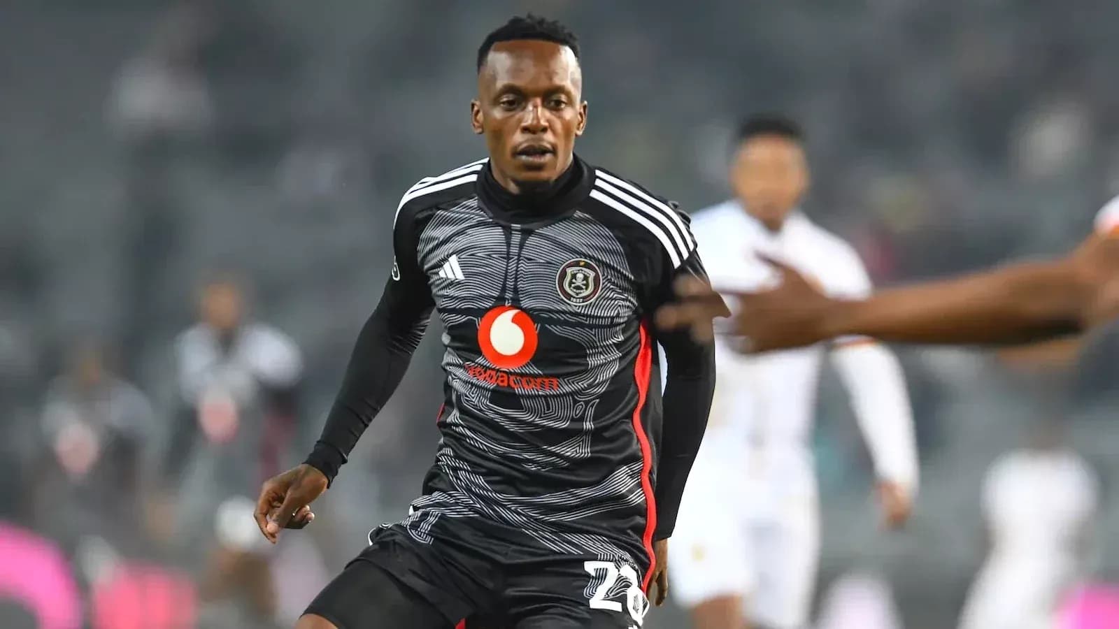 Player in black jersey running during a match Player in black jersey running during a match