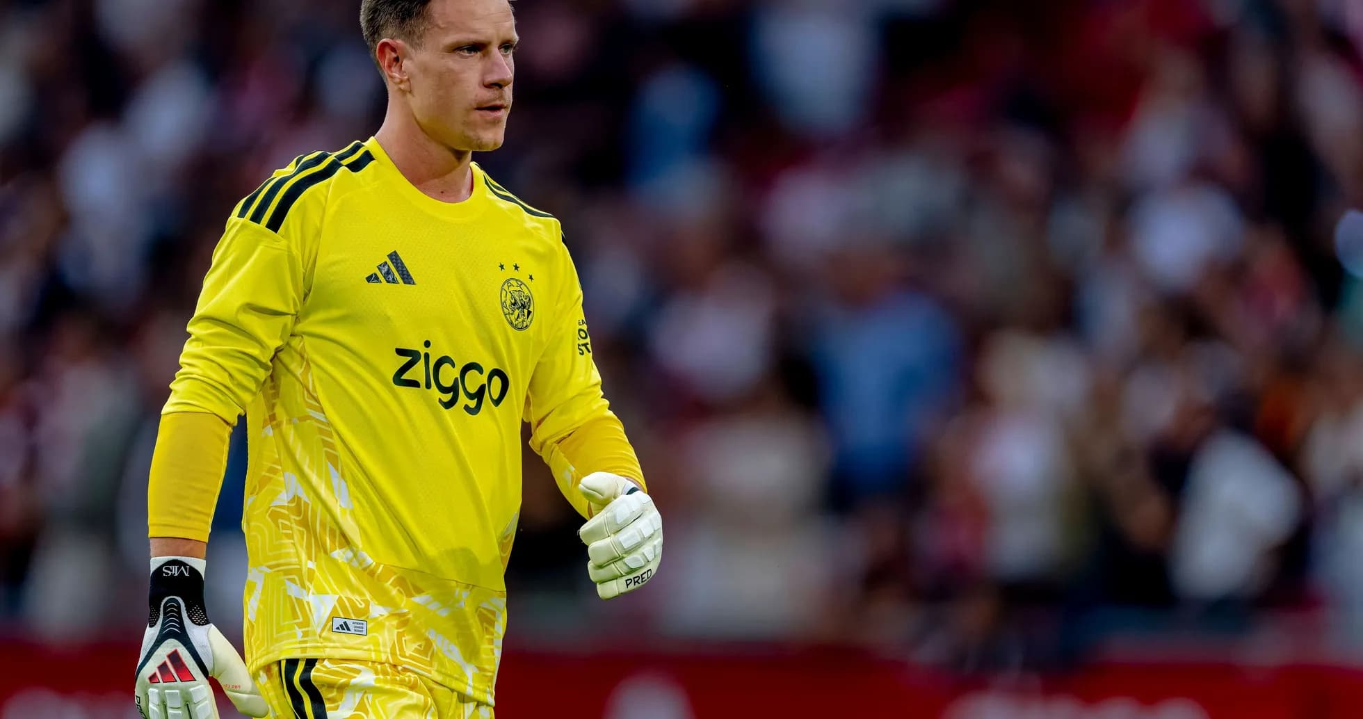 Goalkeeper wearing yellow kit walking on the pitch Goalkeeper wearing yellow kit walking on the pitch