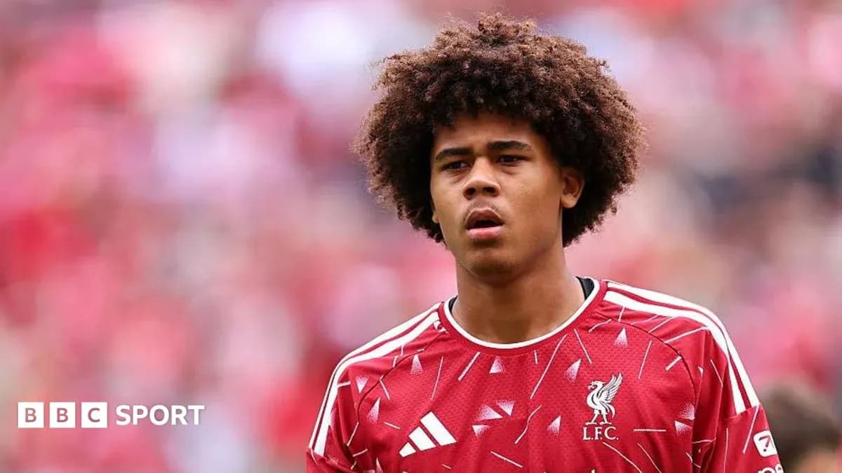 Young player wearing Liverpool jersey on the pitch Young player wearing Liverpool jersey on the pitch