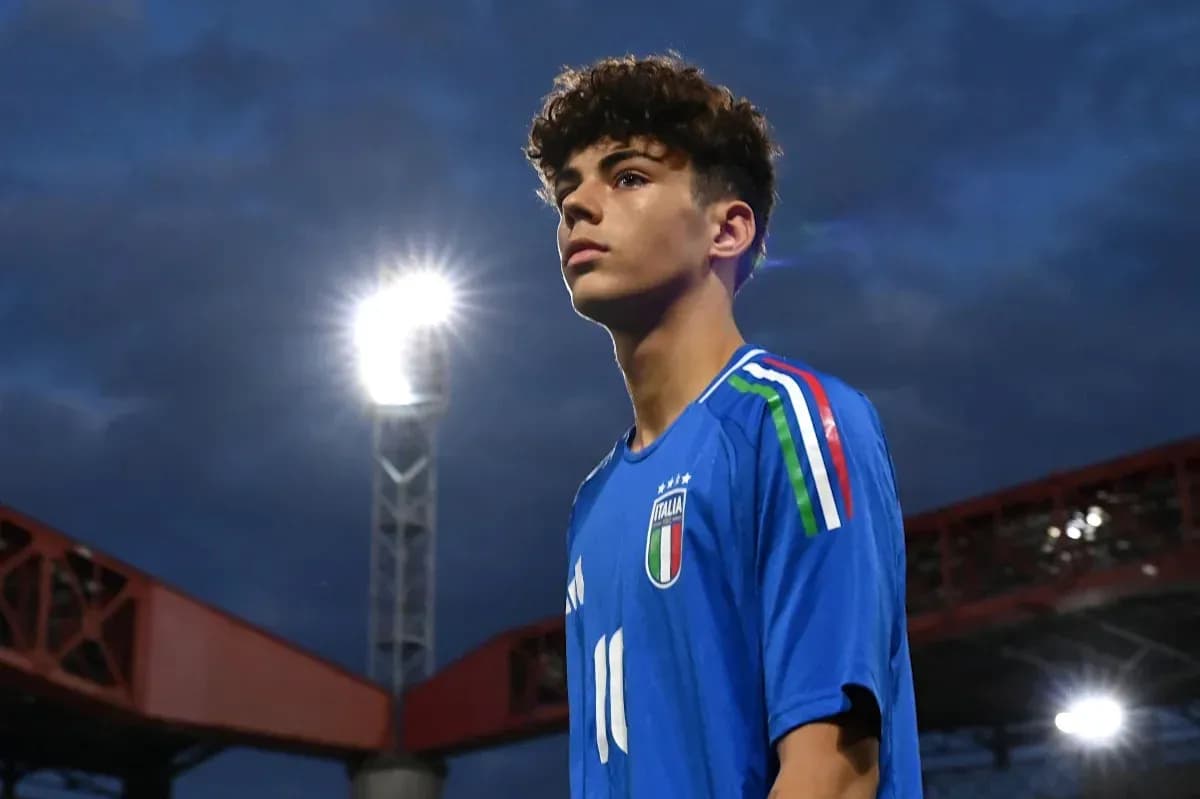 Young player in Italy jersey under stadium lights Young player in Italy jersey under stadium lights