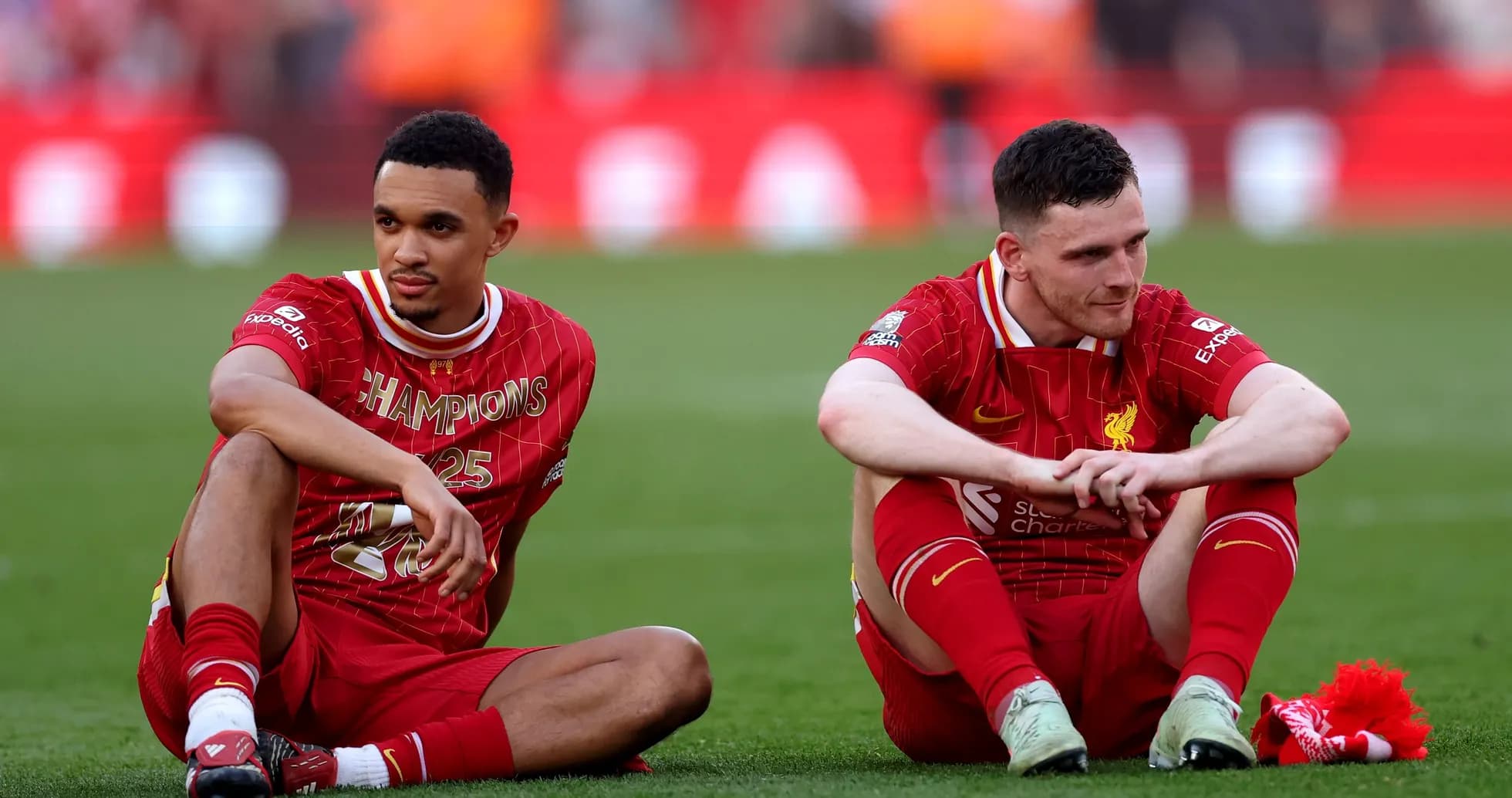 Two Liverpool players sitting on the pitch Two Liverpool players sitting on the pitch