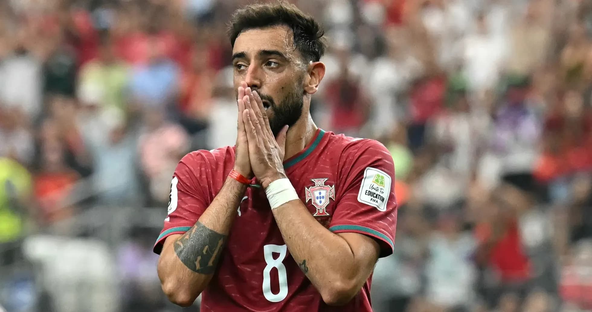 Player in Portugal jersey showing concern on field Player in Portugal jersey showing concern on field