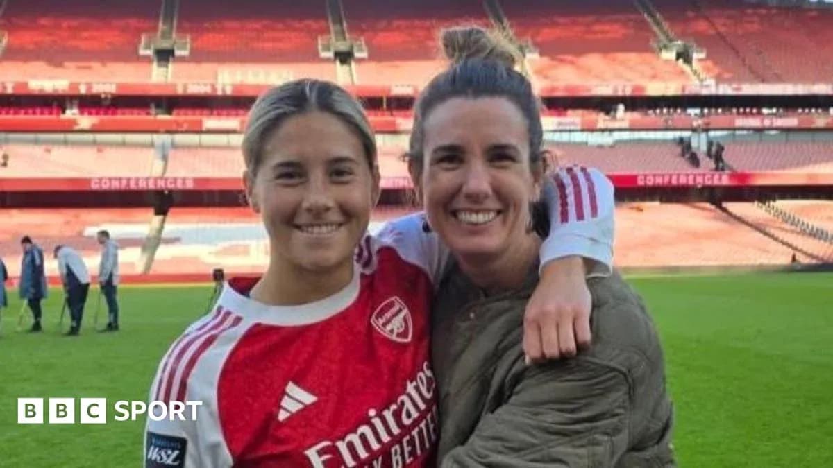 Two female football players posing on the pitch Two female football players posing on the pitch