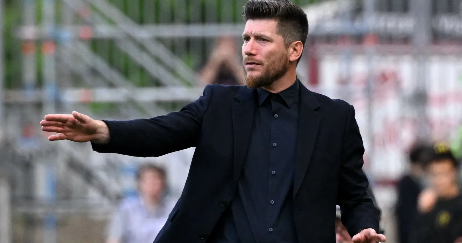 Coach gesturing during a football match on the sidelines Coach gesturing during a football match on the sidelines
