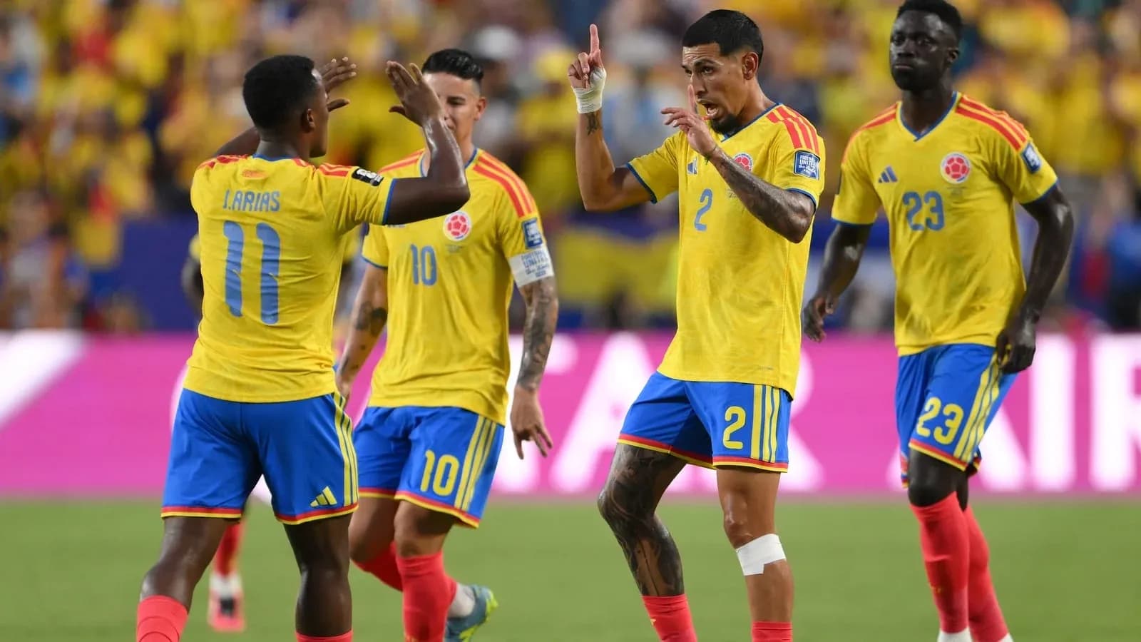 Colombian players celebrating a goal on the field Colombian players celebrating a goal on the field