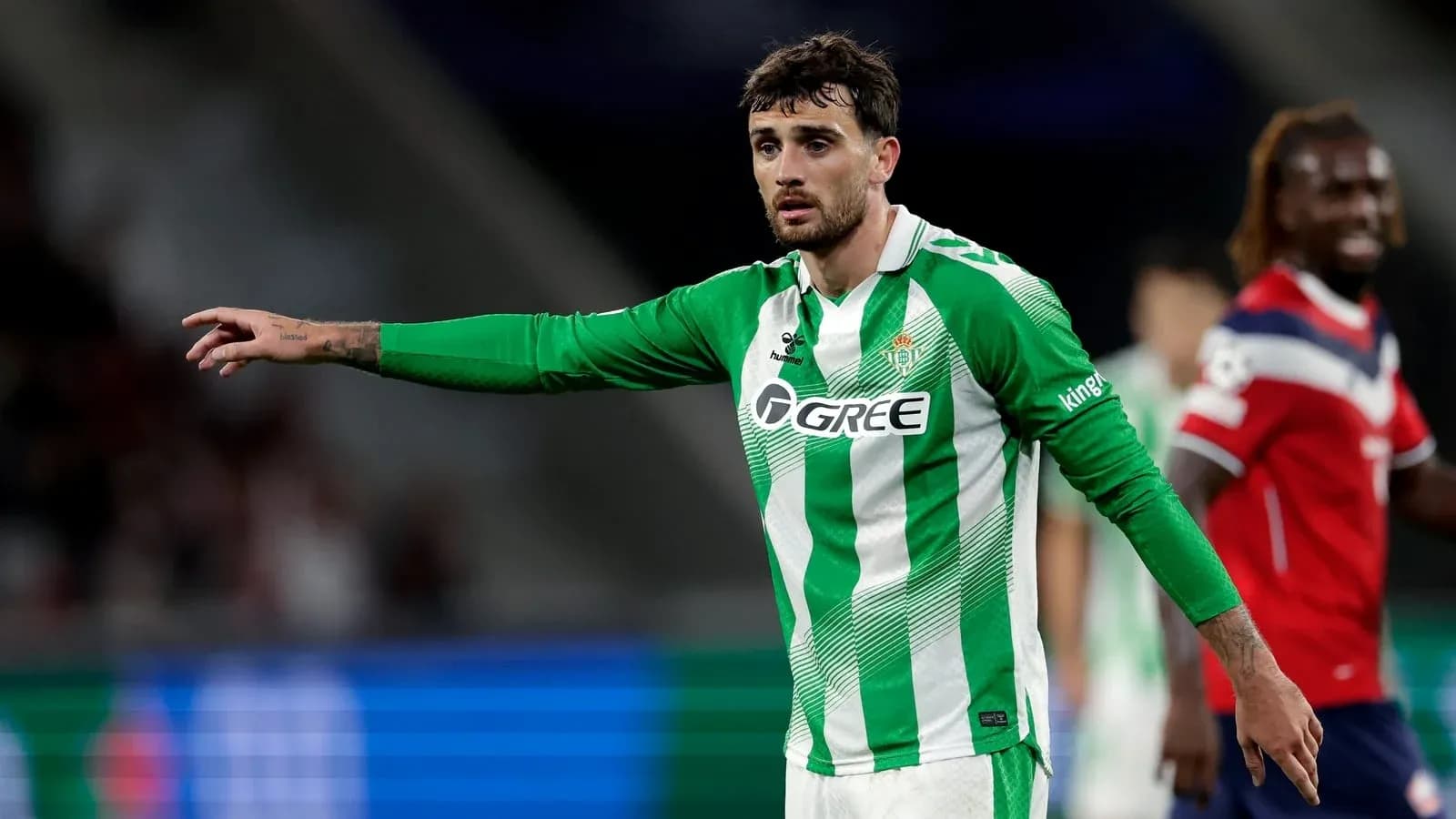 Player gesturing during a football match Player gesturing during a football match