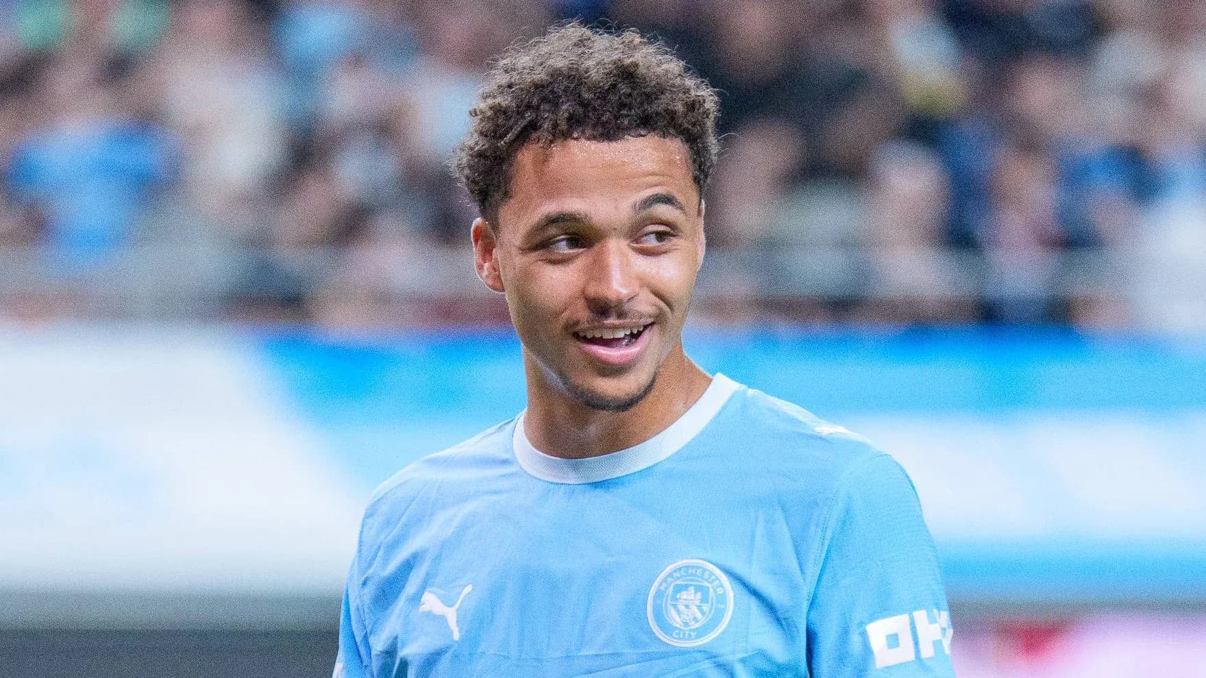 Player smiling in Manchester City training kit Player smiling in Manchester City training kit
