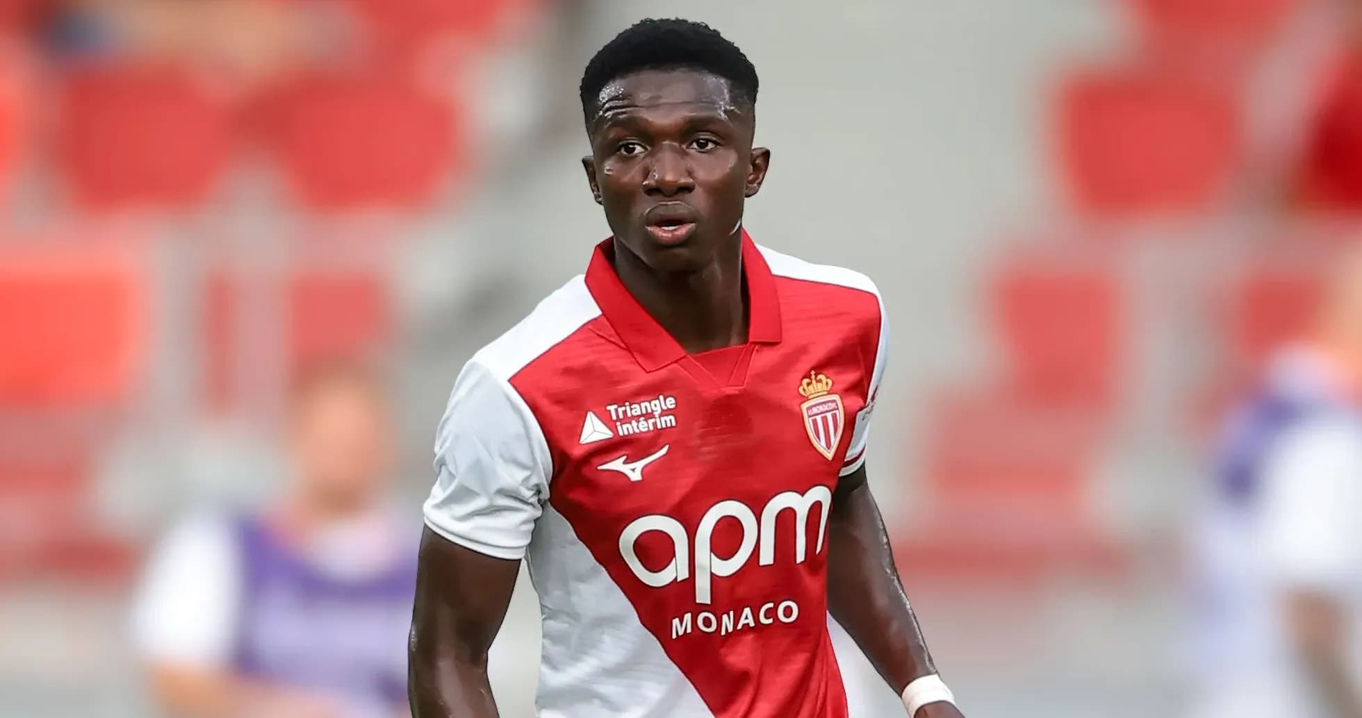Monaco player in red and white kit during match Monaco player in red and white kit during match