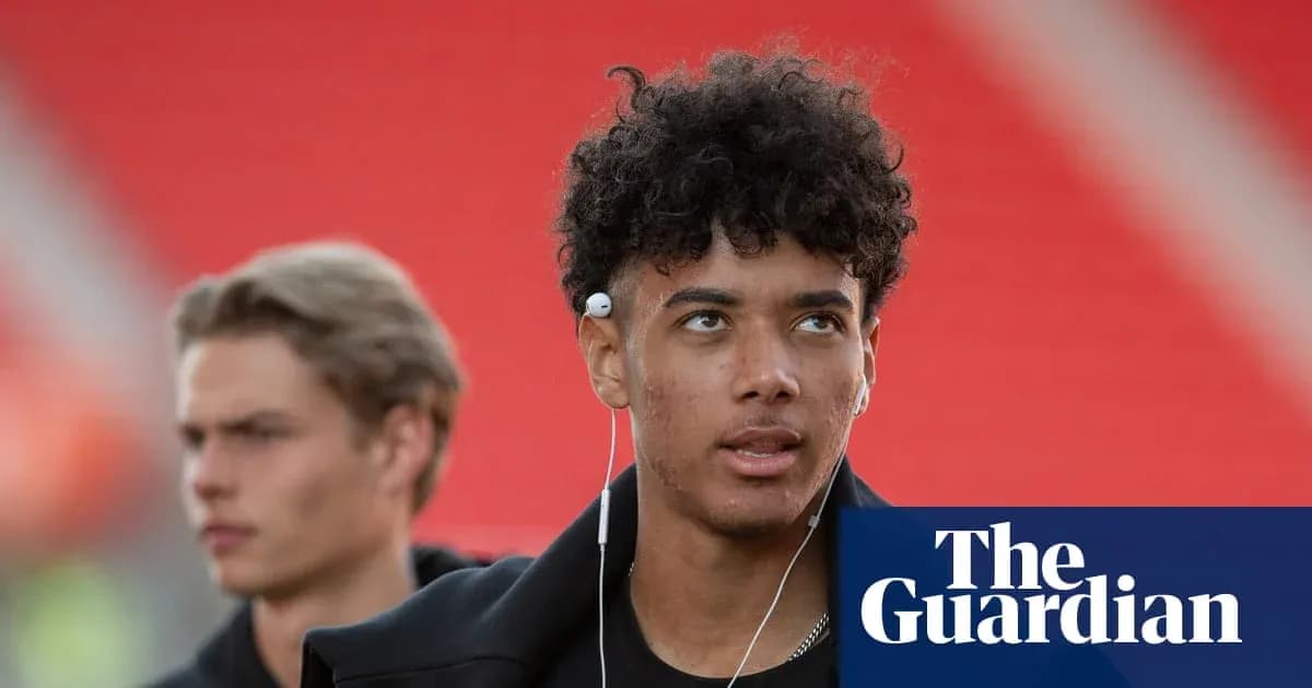 Young player wearing headphones walking before match Young player wearing headphones walking before match