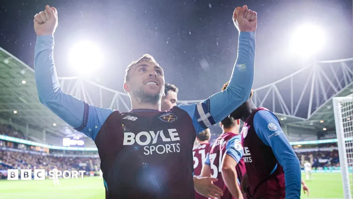 Player celebrating with raised arms after scoring Player celebrating with raised arms after scoring