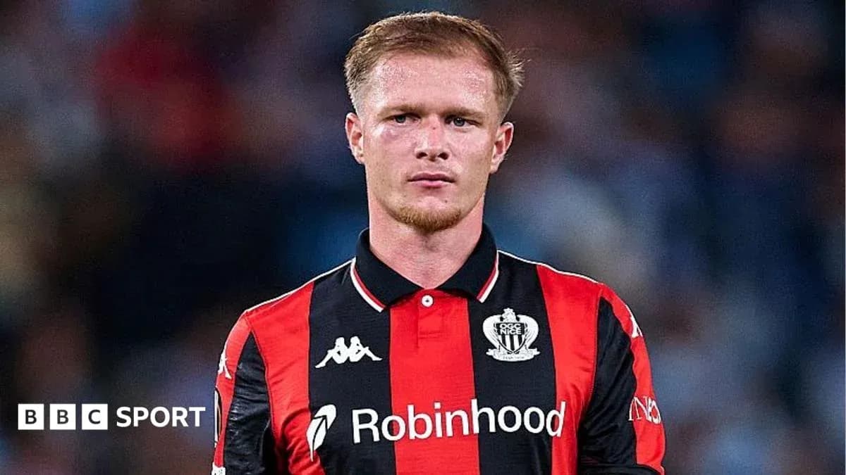 Player in black and red jersey during match Player in black and red jersey during match