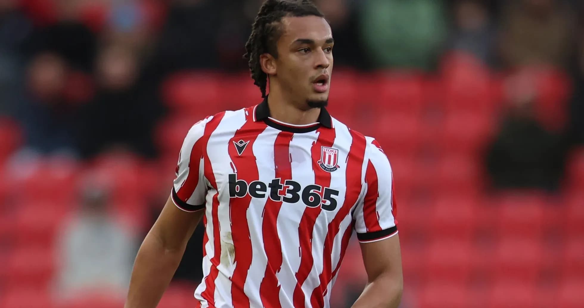 Player in Stoke City jersey during match action Player in Stoke City jersey during match action