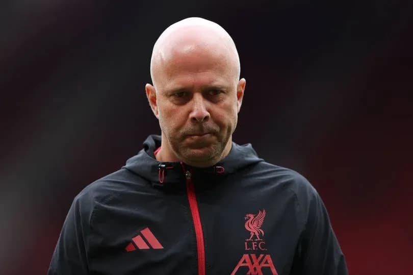 Liverpool FC coach walking on the pitch Liverpool FC coach walking on the pitch