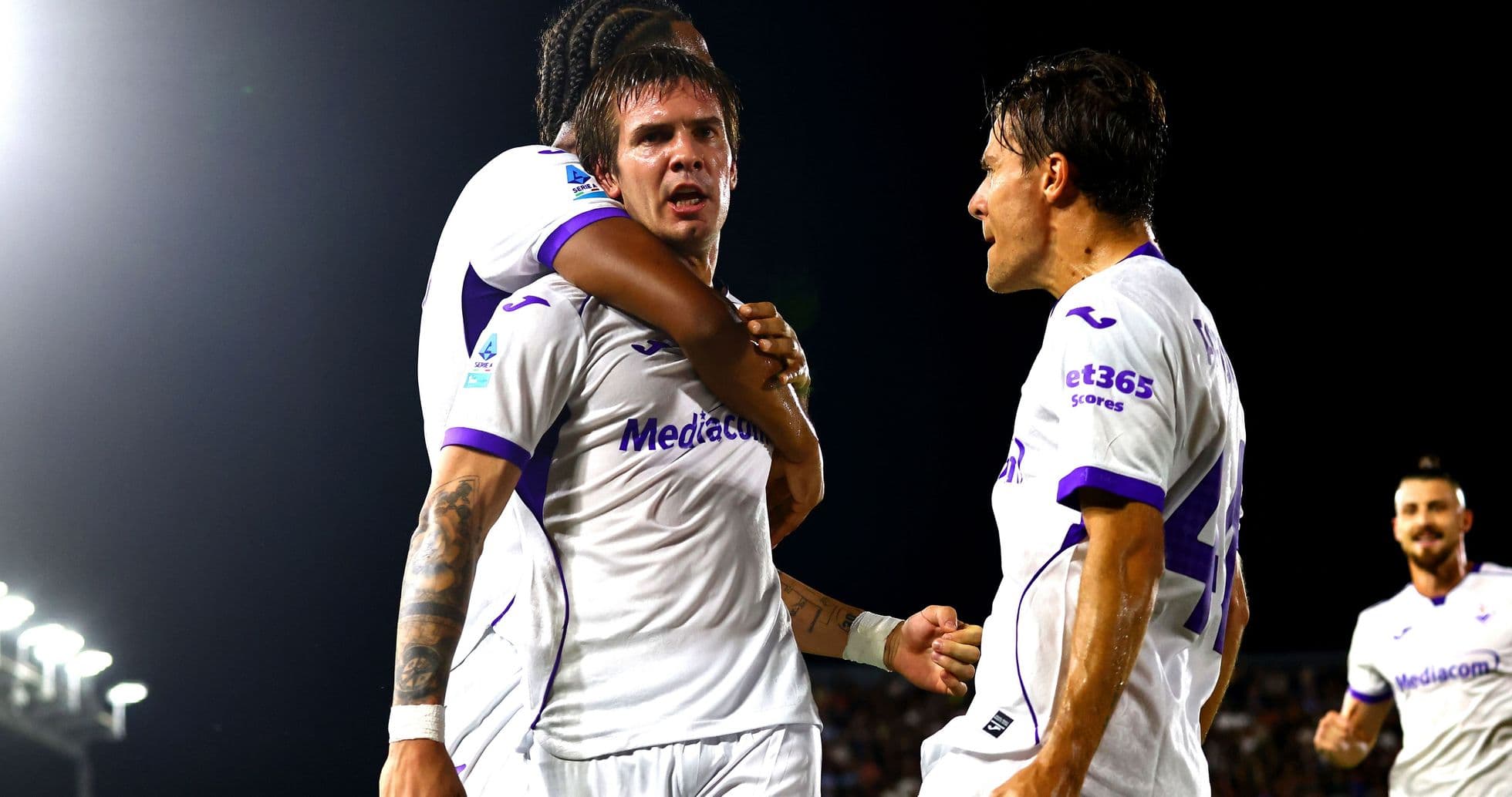 Fiorentina players celebrating a goal together Fiorentina players celebrating a goal together
