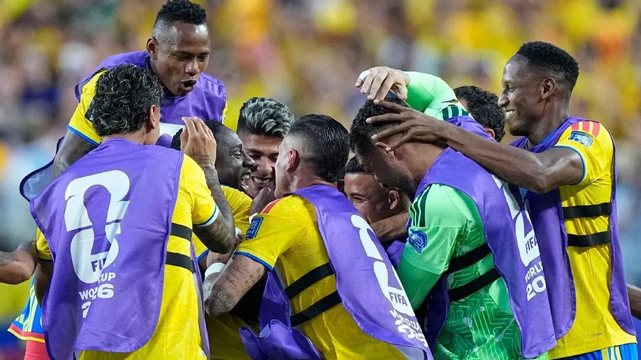 Players celebrating a goal with team jerseys on Players celebrating a goal with team jerseys on