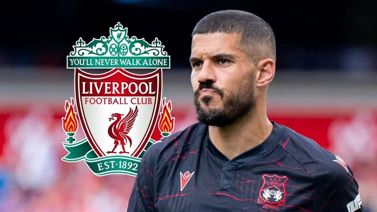 Player in black jersey with Liverpool logo background Player in black jersey with Liverpool logo background