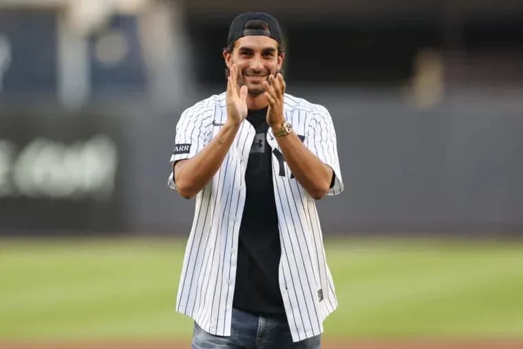 Man in Yankees jersey clapping on field Man in Yankees jersey clapping on field
