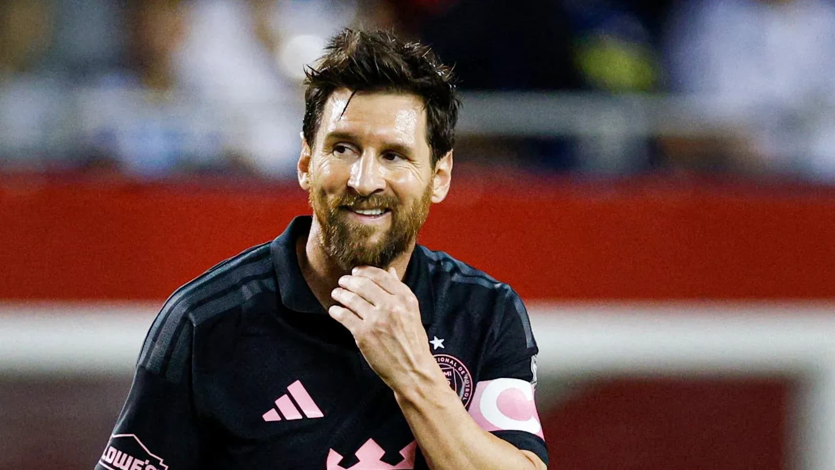 Player in black jersey smiling on the field Player in black jersey smiling on the field