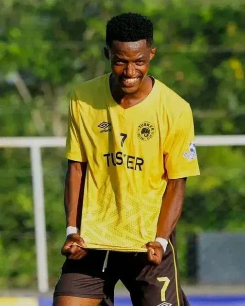 Player celebrating in yellow team jersey on field Player celebrating in yellow team jersey on field