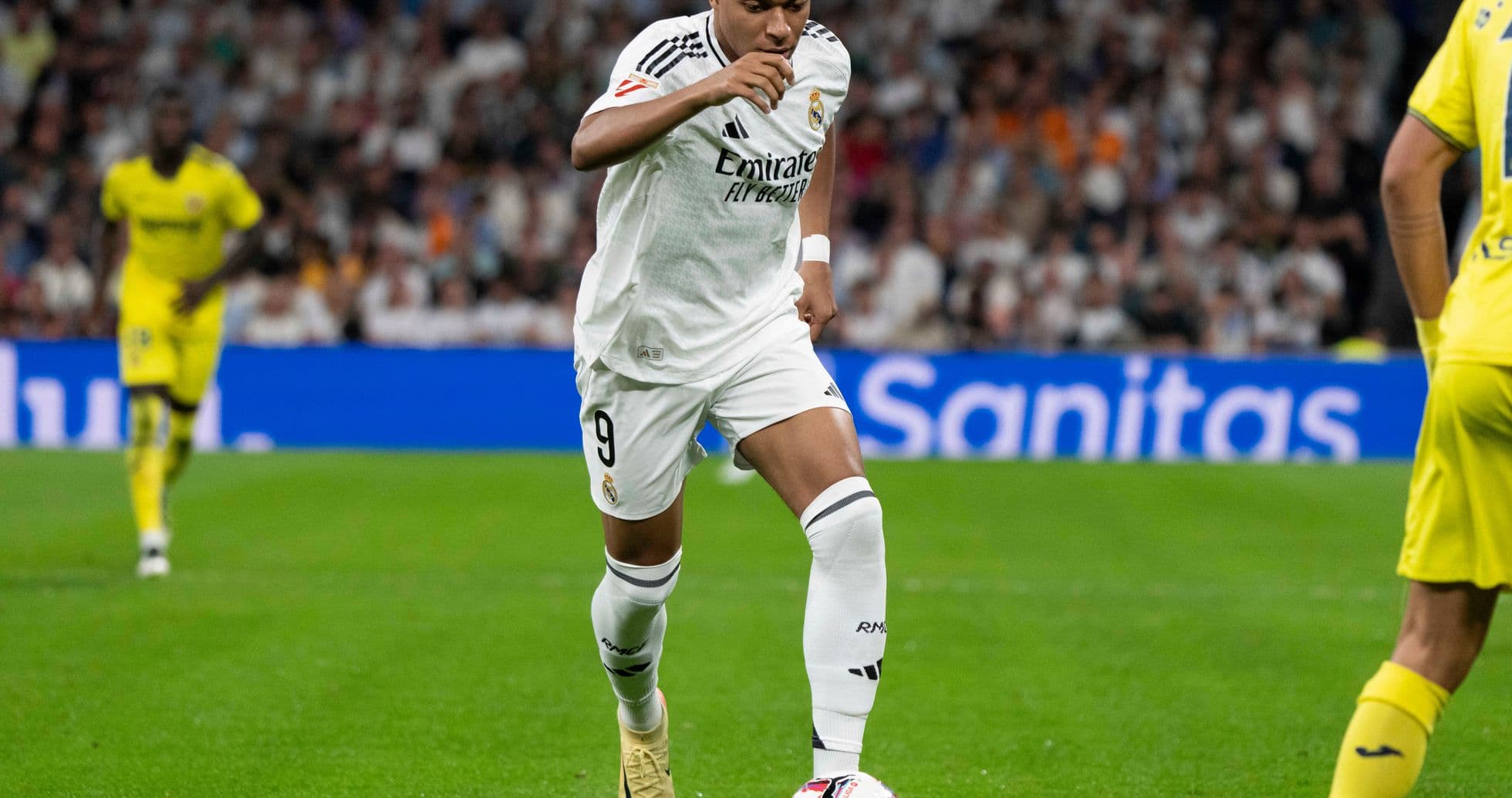 Player dribbling ball during match at stadium Player dribbling ball during match at stadium