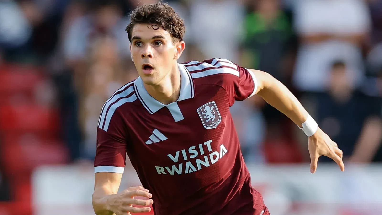 Player running during a football match for Aston Villa Player running during a football match for Aston Villa