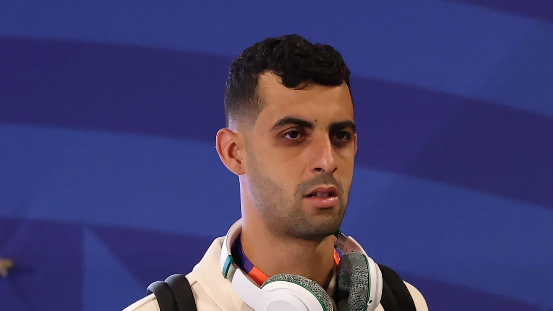 Player arriving with headphones before match Player arriving with headphones before match