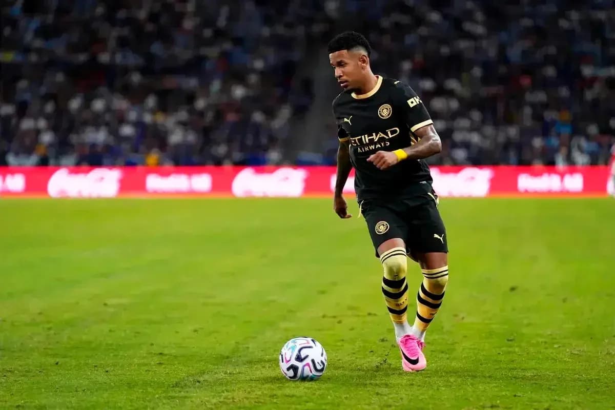Player in black jersey dribbling soccer ball on field Player in black jersey dribbling soccer ball on field
