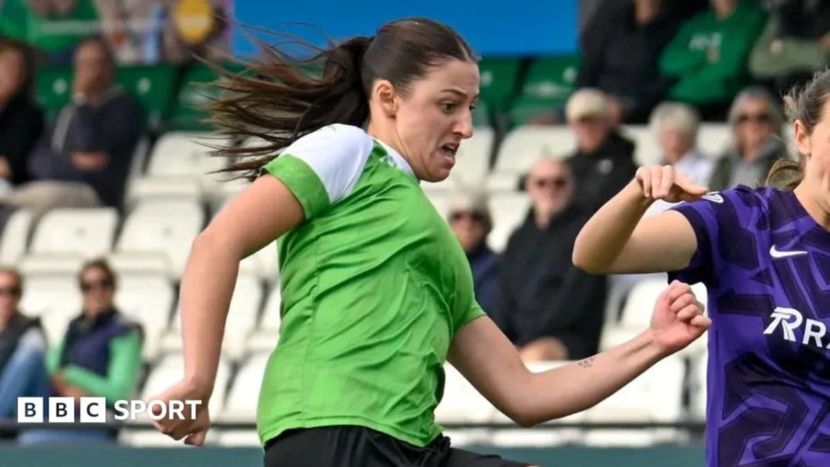 Player in green jersey challenging opponent for the ball Player in green jersey challenging opponent for the ball