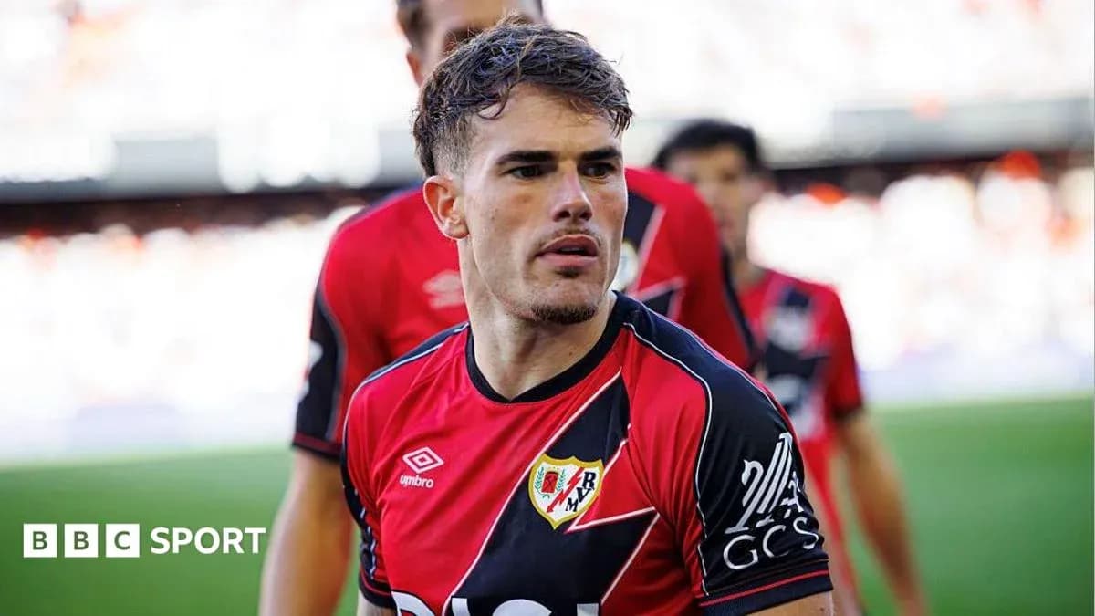 Player in red and black jersey during match warm-up Player in red and black jersey during match warm-up