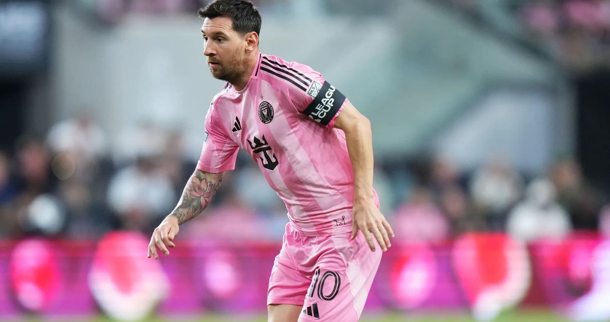 Lionel Messi running in pink Inter Miami jersey Lionel Messi running in pink Inter Miami jersey