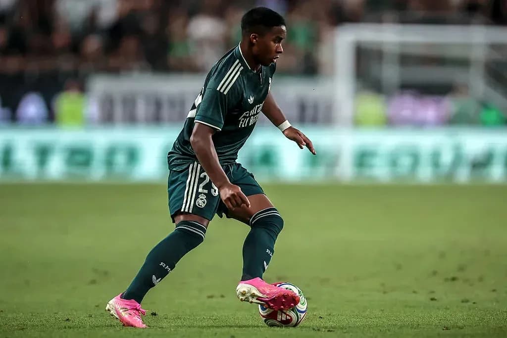 Player dribbling ball during match in green kit Player dribbling ball during match in green kit
